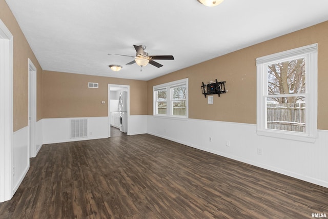 unfurnished living room with ceiling fan and dark wood-type flooring