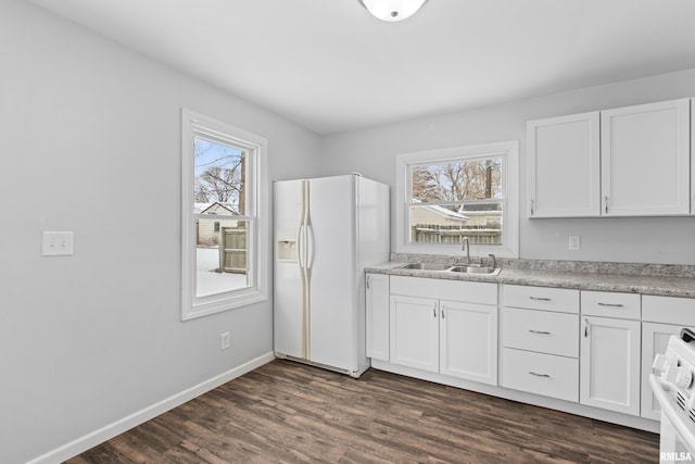 kitchen with electric stove, sink, white fridge with ice dispenser, dark hardwood / wood-style flooring, and white cabinetry