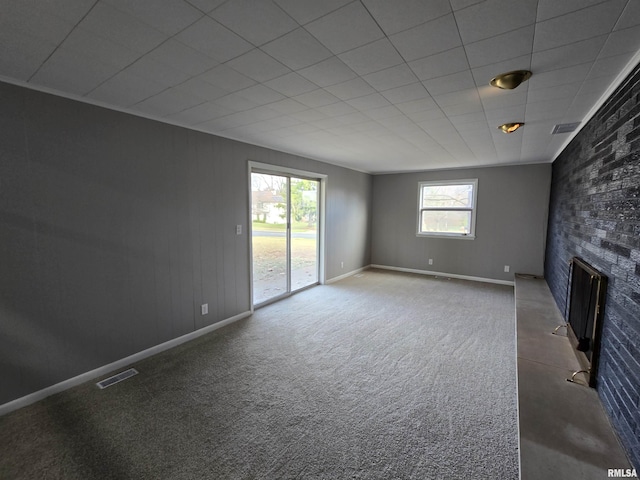 unfurnished living room featuring carpet flooring and a fireplace