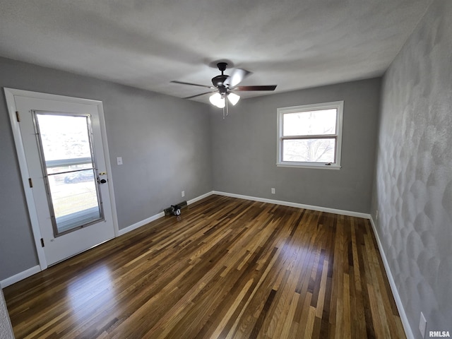 unfurnished room featuring dark hardwood / wood-style floors and ceiling fan