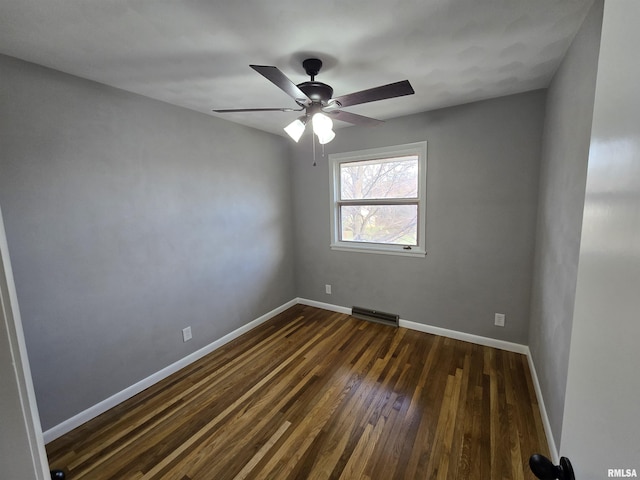 spare room with ceiling fan and dark hardwood / wood-style floors