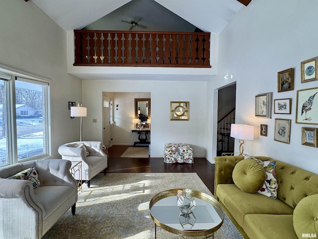 living room with hardwood / wood-style floors, ceiling fan, and high vaulted ceiling