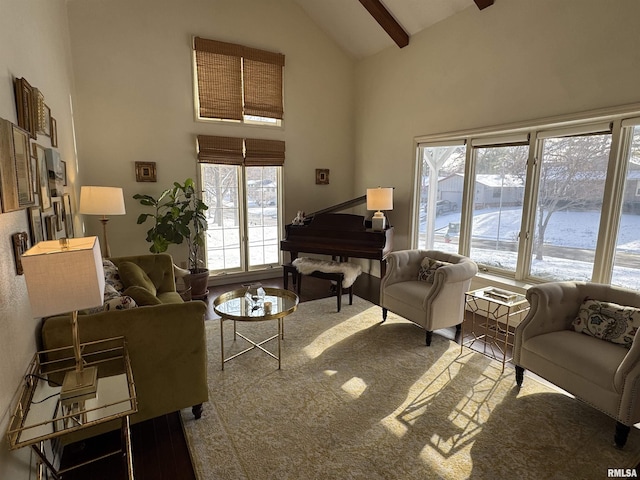 living room with beamed ceiling and high vaulted ceiling