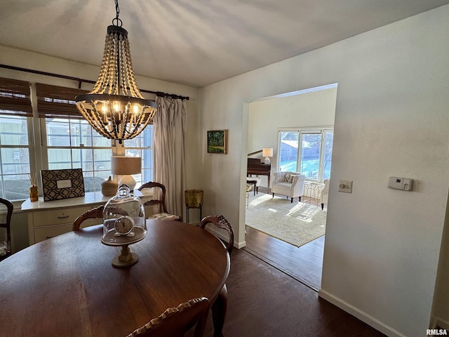 dining room featuring dark hardwood / wood-style floors and a notable chandelier