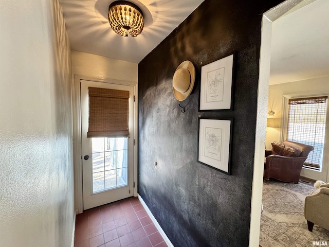 doorway to outside featuring tile patterned floors and a healthy amount of sunlight