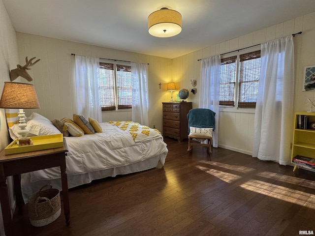 bedroom featuring multiple windows and dark wood-type flooring