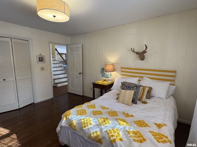 bedroom with dark hardwood / wood-style flooring and a closet