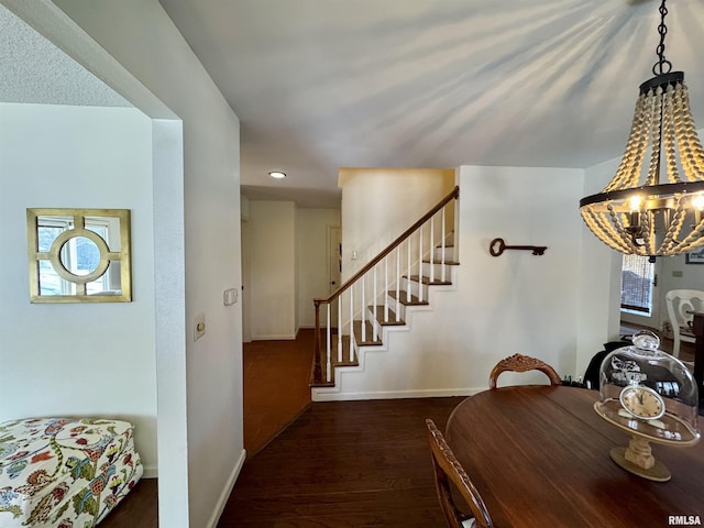 dining space featuring an inviting chandelier and dark wood-type flooring