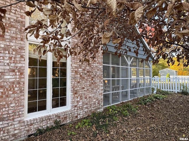 view of side of home with a sunroom