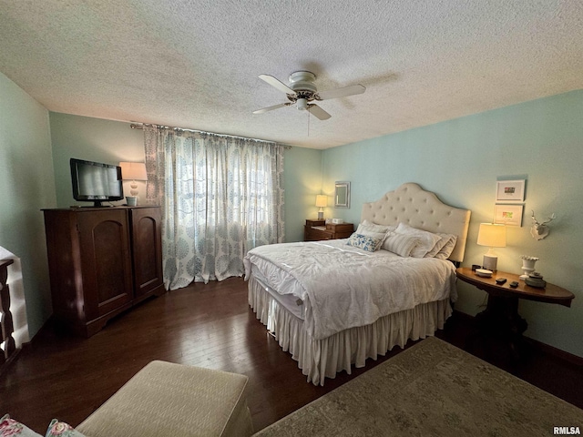 bedroom with a textured ceiling, ceiling fan, and dark wood-type flooring