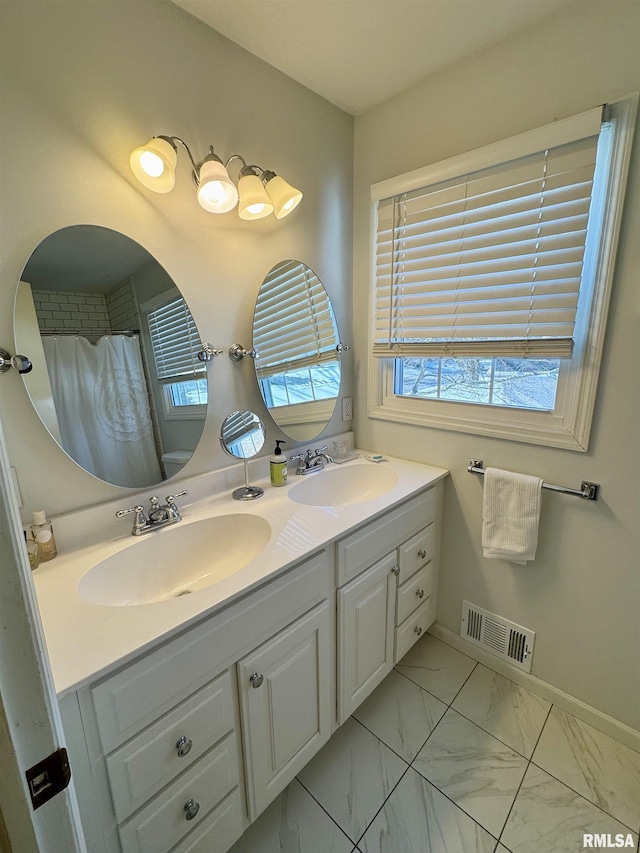 bathroom featuring a shower with shower curtain, plenty of natural light, and vanity