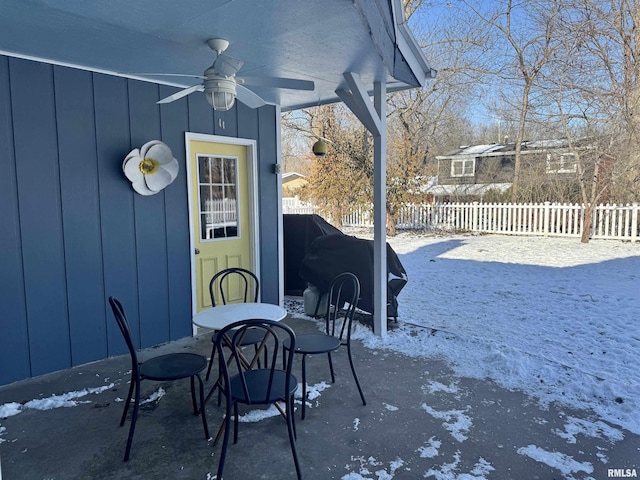 snow covered patio featuring ceiling fan