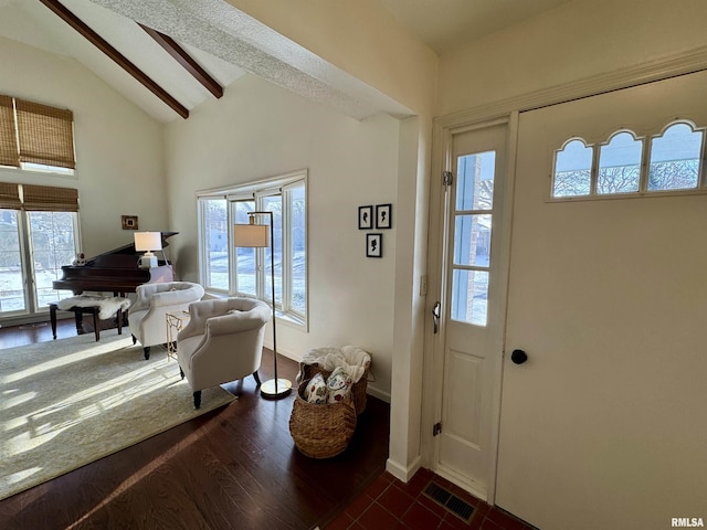 entryway featuring vaulted ceiling with beams and dark hardwood / wood-style floors