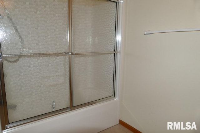 bathroom featuring shower / bath combination with glass door