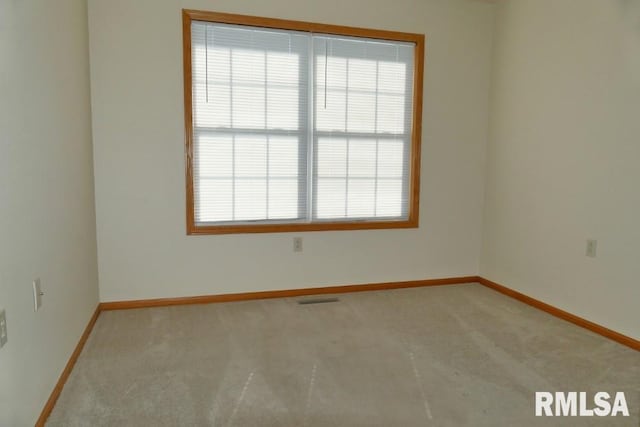 carpeted spare room with plenty of natural light