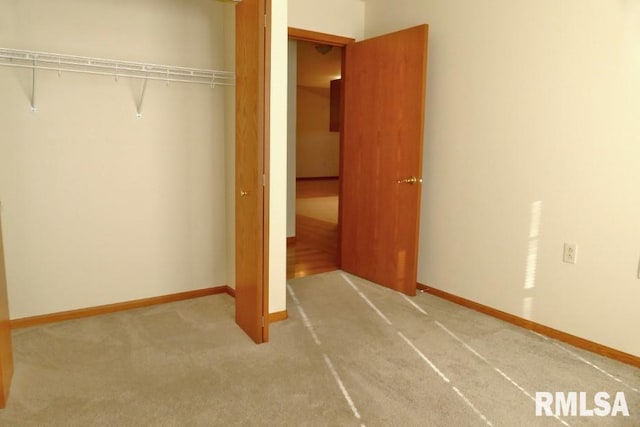 unfurnished bedroom featuring carpet and a closet