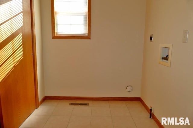 clothes washing area featuring hookup for an electric dryer, hookup for a washing machine, and light tile patterned floors