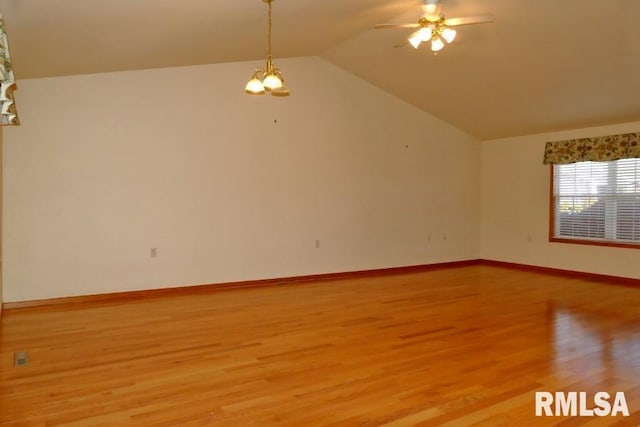 spare room with lofted ceiling, ceiling fan, and light wood-type flooring