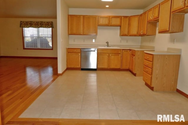 kitchen featuring dishwasher, light wood-type flooring, and sink