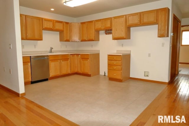 kitchen featuring dishwasher, light wood-type flooring, and sink