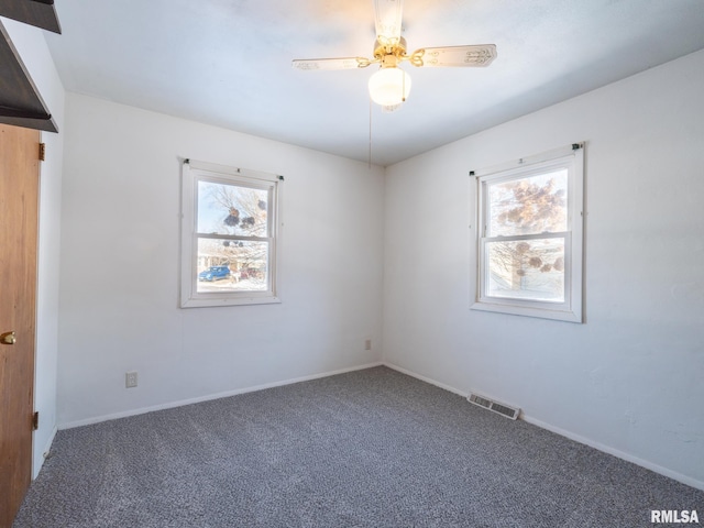 empty room featuring carpet, plenty of natural light, and ceiling fan