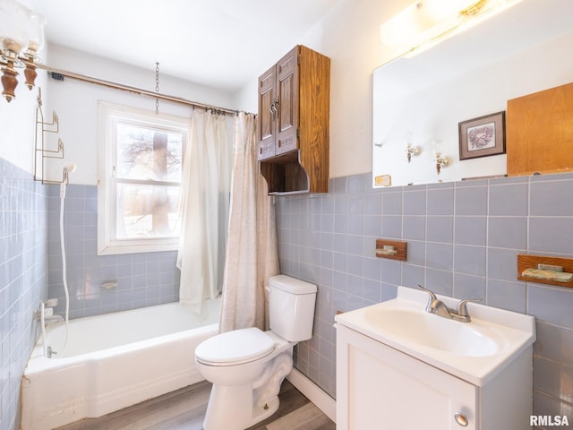 full bathroom with wood-type flooring, vanity, shower / tub combo, and toilet