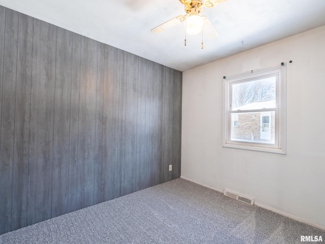 empty room featuring carpet flooring and ceiling fan