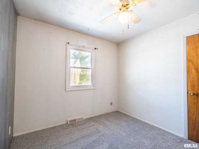 empty room with ceiling fan and carpet floors