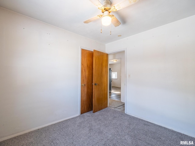 empty room with ceiling fan and carpet floors