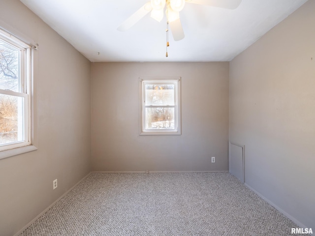 carpeted spare room with ceiling fan