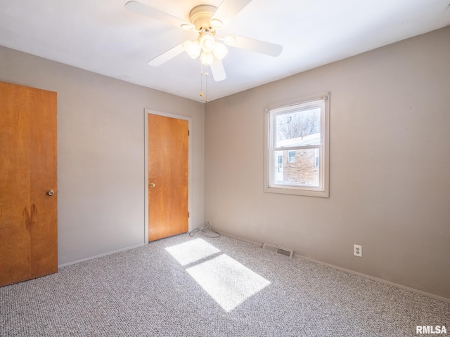 carpeted empty room with ceiling fan