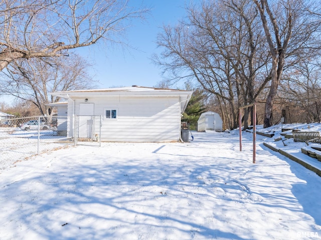 snow covered property with a storage unit