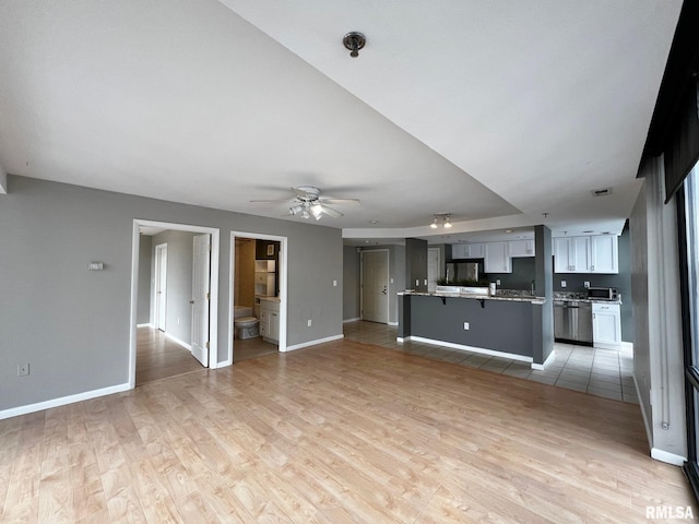 unfurnished living room featuring hardwood / wood-style floors and ceiling fan