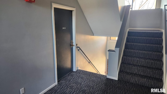 stairs featuring carpet floors and vaulted ceiling