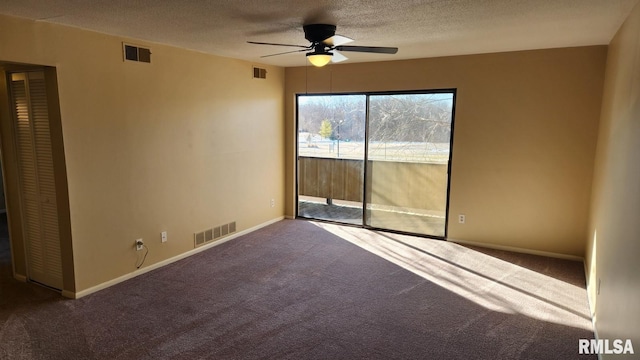 unfurnished room featuring a textured ceiling, carpet floors, and ceiling fan