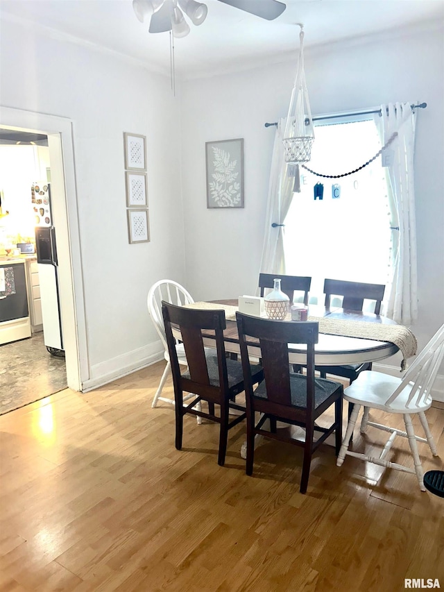 dining area with hardwood / wood-style floors and ceiling fan