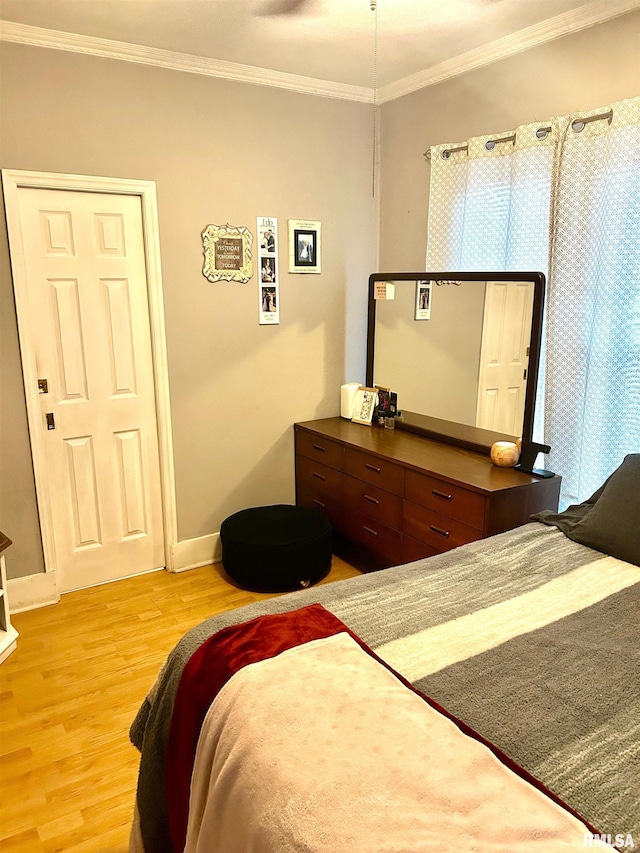 bedroom featuring light hardwood / wood-style floors and ornamental molding