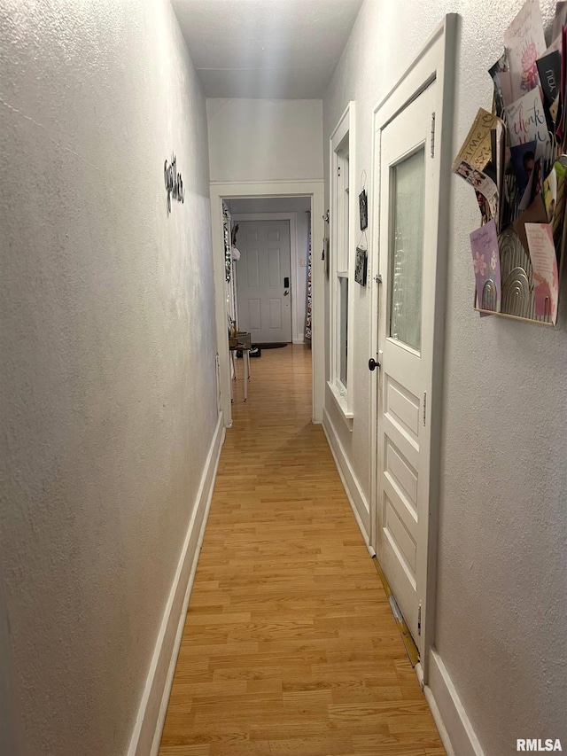 corridor with light hardwood / wood-style flooring