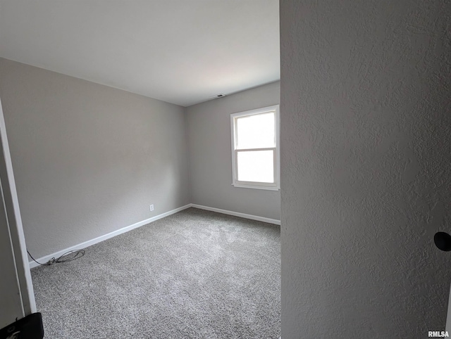 unfurnished room featuring carpet