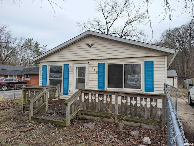 view of front facade with fence and a wooden deck