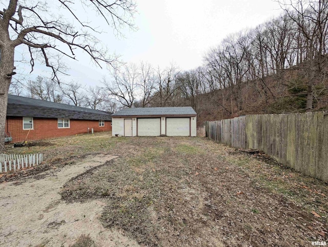 view of yard featuring an outbuilding and a garage