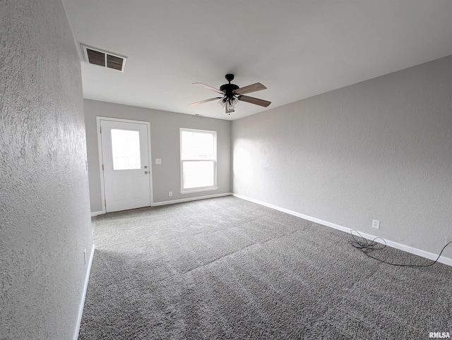 spare room with carpet flooring and ceiling fan