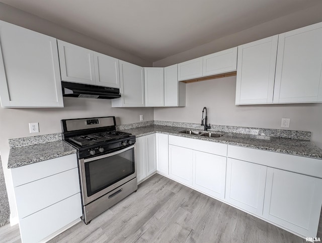 kitchen with stainless steel gas stove, sink, light hardwood / wood-style flooring, and white cabinets