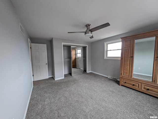 unfurnished bedroom with ceiling fan, a closet, and light carpet