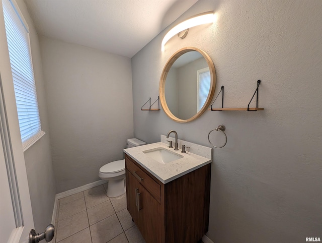 bathroom with tile patterned flooring, vanity, and toilet