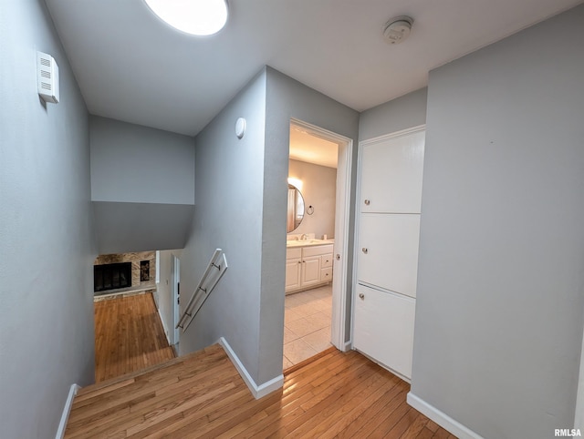 hall featuring light wood-type flooring and sink