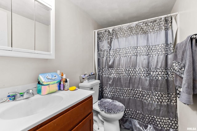 bathroom featuring vanity, toilet, and walk in shower