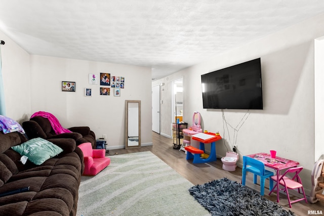 living room featuring a textured ceiling and light hardwood / wood-style flooring