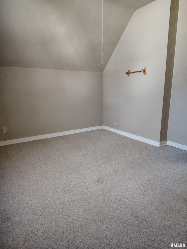 bonus room with carpet and vaulted ceiling