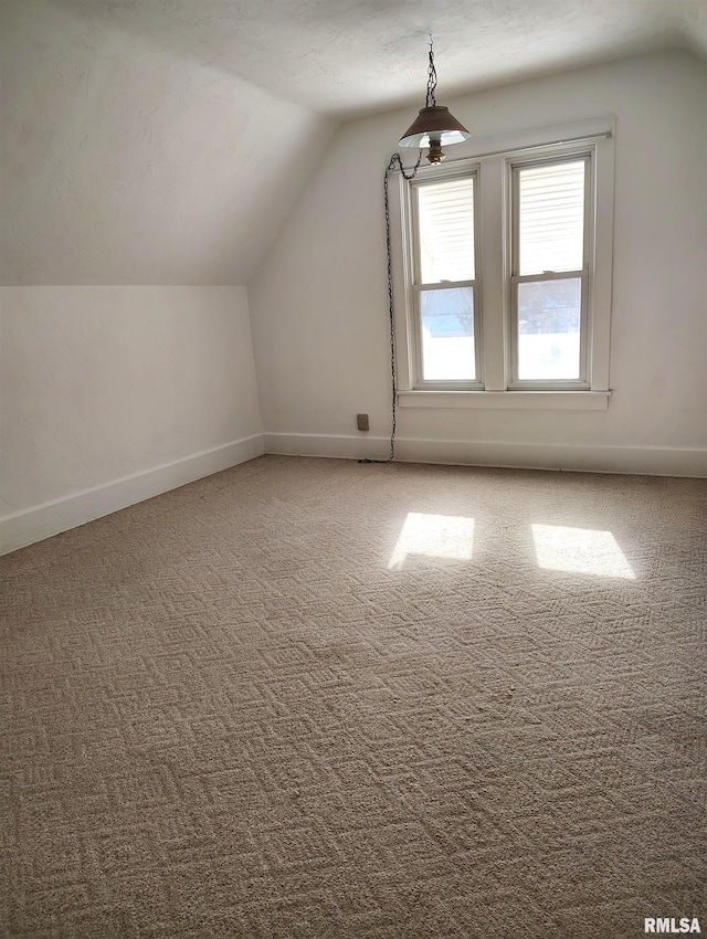 additional living space with carpet floors and lofted ceiling